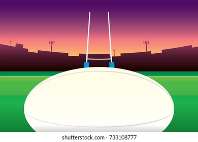 Rugby ball isolated on green field and stadium on purple sky background.