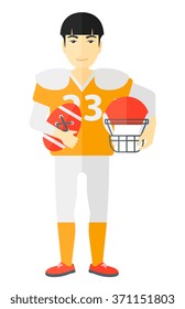 Rugby player with ball and helmet in hands.