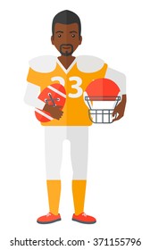 Rugby player with ball and helmet in hands.
