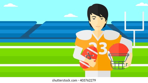 Rugby player with ball and helmet in hands.