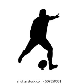 Rugby player kicking ball, vector silhouette