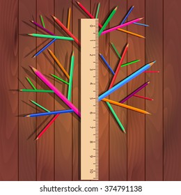 Ruler, colored pencils, stationery tree of tools on a wooden background