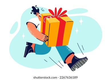 Running man holds huge gift box to wish girlfriend or friend happy birthday or other holiday. Hurrying courier hurries to present gift ordered in online store with door-to-door delivery 