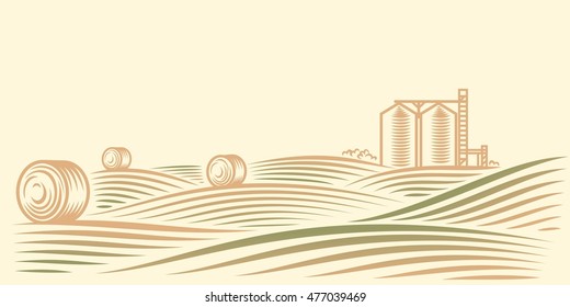 Rural landscape with fields, haystacks and grain elevator