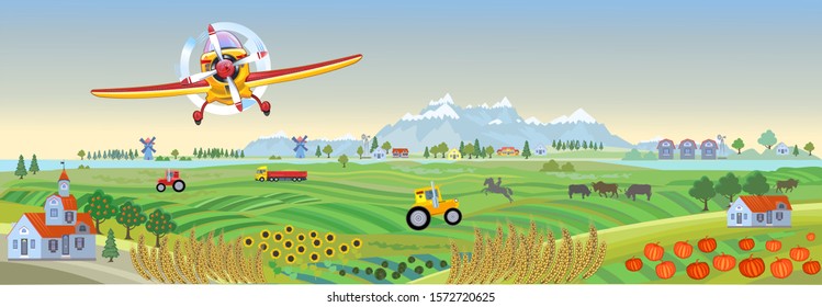 Rural landscape with a wheat field and a village.Farm panorama on a hill.