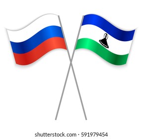 Russian and Basotho crossed flags. Russia combined with Lesotho isolated on white. Language learning, international business or travel concept.