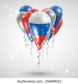 Russian flag on air balls in heart-shaped. Celebration and gifts. Ribbon in the colors are twisted under the balloon. Independence Day. Balloons on the feast of the national