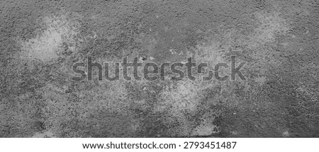 Rustic concrete wall texture with rough stone surface and weathered cement pattern in gray color. Grunge background with scratches and aged industrial material for architectural or vintage design.