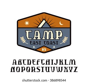 Rustic serif font and camping emblem. Graphic design for t-shirt. Color print on white background