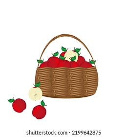 Rustic wicker basket full of  ripe red apples with green leaf and half of apple on white background with copy space.