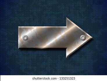 Rusty metal arrow with rivets on grungy background