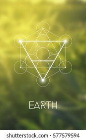 Sacred Geometry Earth Element Symbol Inside Metatron Cube And Flower Of Life In Front Of Natural Blurry Background.