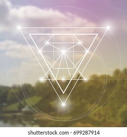 Sacred geometry hipster symbol in front of blurry photo background for poster or music album cover 