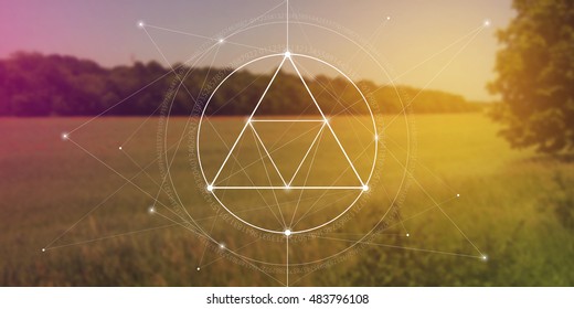 Sacred geometry of the nature. Website banner with interlocking geometry shapes, flows of energy and particles in front of colorful field landscape.