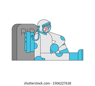 Sad Astronaut is sitting by grave. Spaceman and headstone