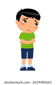 Sad and confused boy stands with his arms crossed; his shoulders slumped and a worried expression on his face.; Concept of emotions confusion; anxiety; uncertainty; bewilderment; worry; inner chaos.