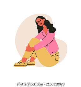 Sad crying woman, sitting and hugging her knees