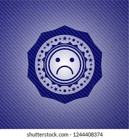 sad face icon with denim texture
