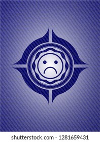 sad face icon with denim texture