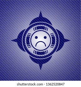sad face icon inside badge with jean texture