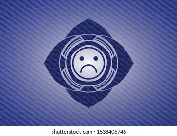 sad face icon inside badge with jean texture