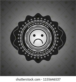 sad face icon inside black badge