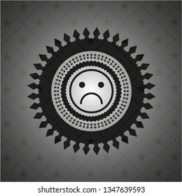 sad face icon inside black emblem