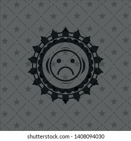 sad face icon inside black emblem