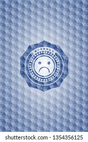 sad face icon inside blue emblem with geometric pattern background.