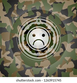 sad face icon inside camouflage texture
