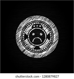 sad face icon inside chalk emblem