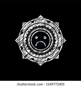 sad face icon inside chalk emblem