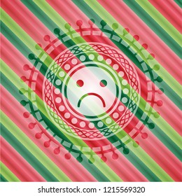 sad face icon inside christmas badge background.