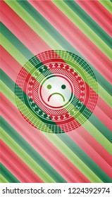 sad face icon inside christmas colors badge.