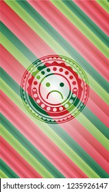 sad face icon inside christmas colors style badge.