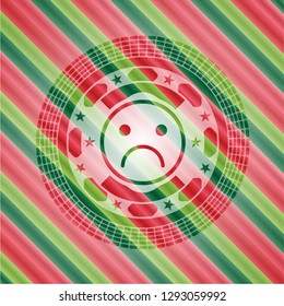 sad face icon inside christmas colors style emblem.