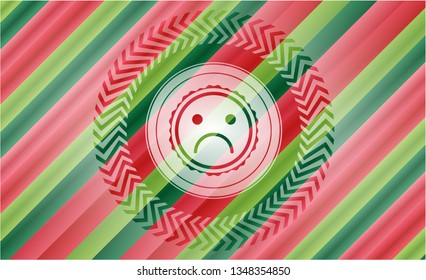 sad face icon inside christmas colors style badge.