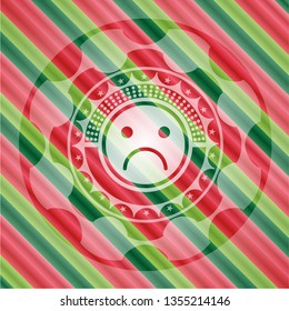 sad face icon inside christmas colors emblem.