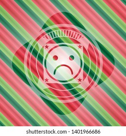 sad face icon inside christmas colors emblem.