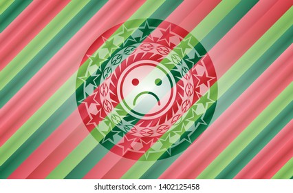 sad face icon inside christmas emblem.