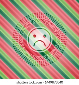 sad face icon inside christmas colors emblem.