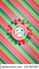 sad face icon inside christmas colors style emblem.