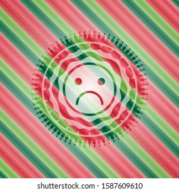 sad face icon inside christmas emblem.