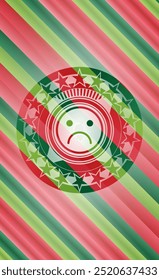 sad face icon inside christmas colors emblem. 