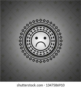 sad face icon inside dark emblem