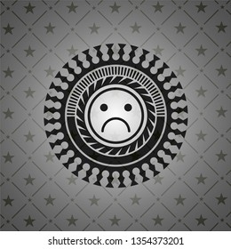 sad face icon inside dark emblem