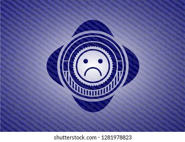 sad face icon inside emblem with denim high quality background