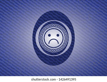 sad face icon inside emblem with denim high quality background