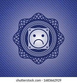 sad face icon inside emblem with jean background