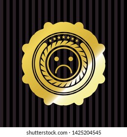 sad face icon inside gold emblem